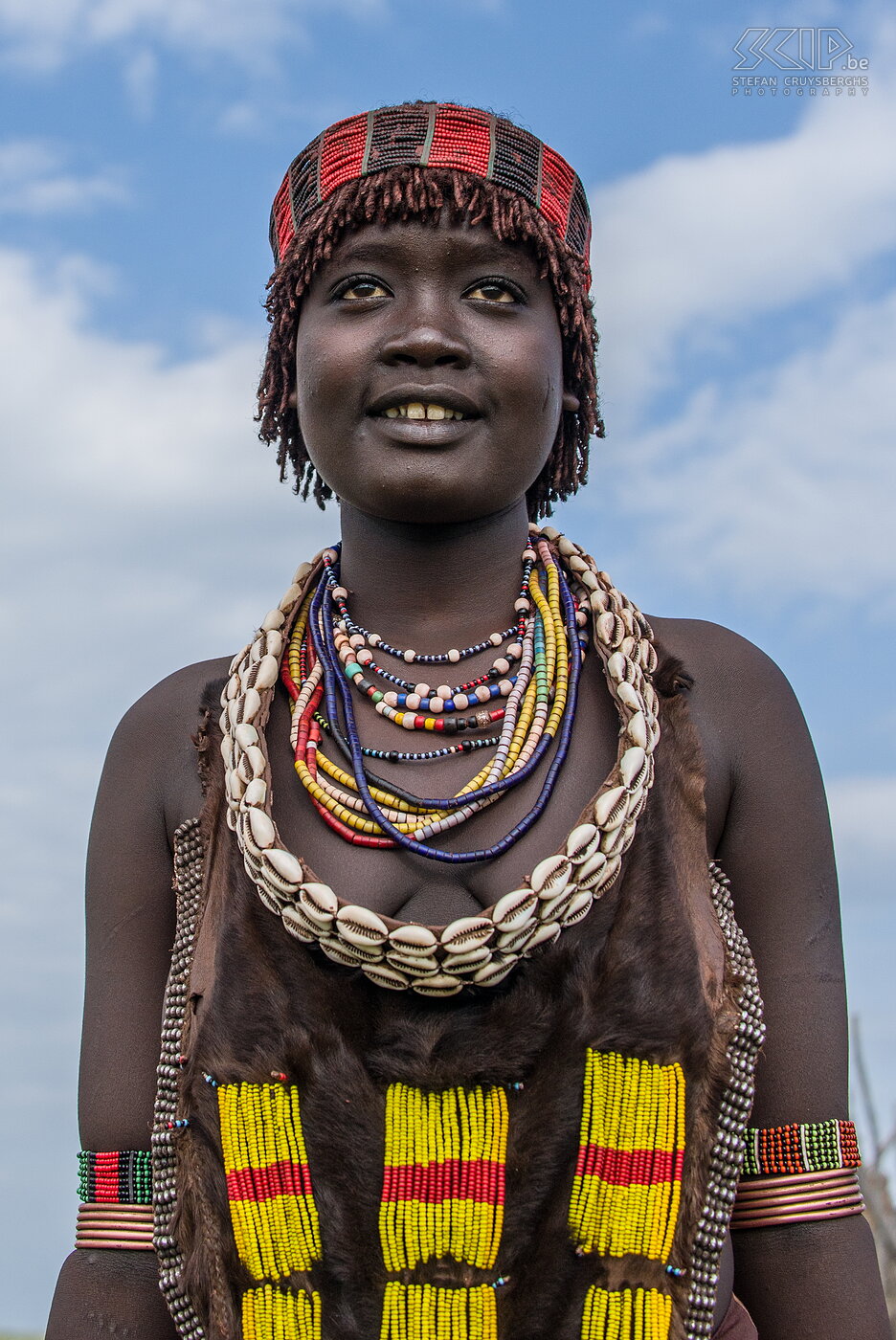 Turmi - Young Hamer woman The Hamer are famous for their traditional bull jumping which is a rite of passage for men coming of age.  A man must run over a line of 10 to 30 bulls without falling. During this ceremony, the women whip themselfs on their bare backs.<br />
<br />
Visiting the Omo valley and the 8 tribes was a wonderful and unique experience and I was able to make some really good portrait photos. But I’m not sure if I would recommend the trip because you have to drive long distances, you see a lot of poverty, people are begging to take photos, you have to pay for each photo separately and it is quite difficult to shoot photos of the daily life. Stefan Cruysberghs